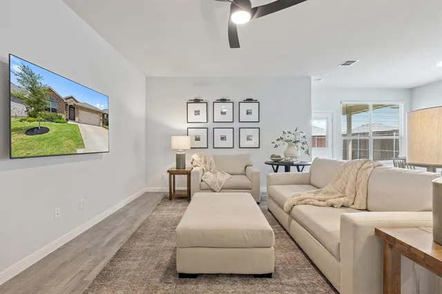 a living room with furniture and a painting on the wall