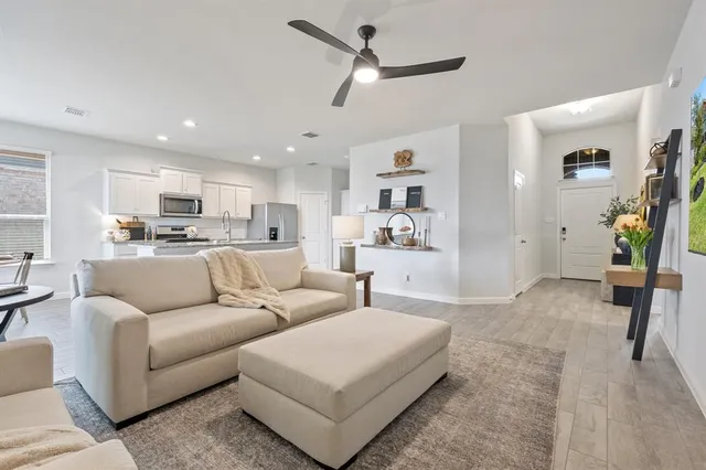 a living room with furniture and kitchen view