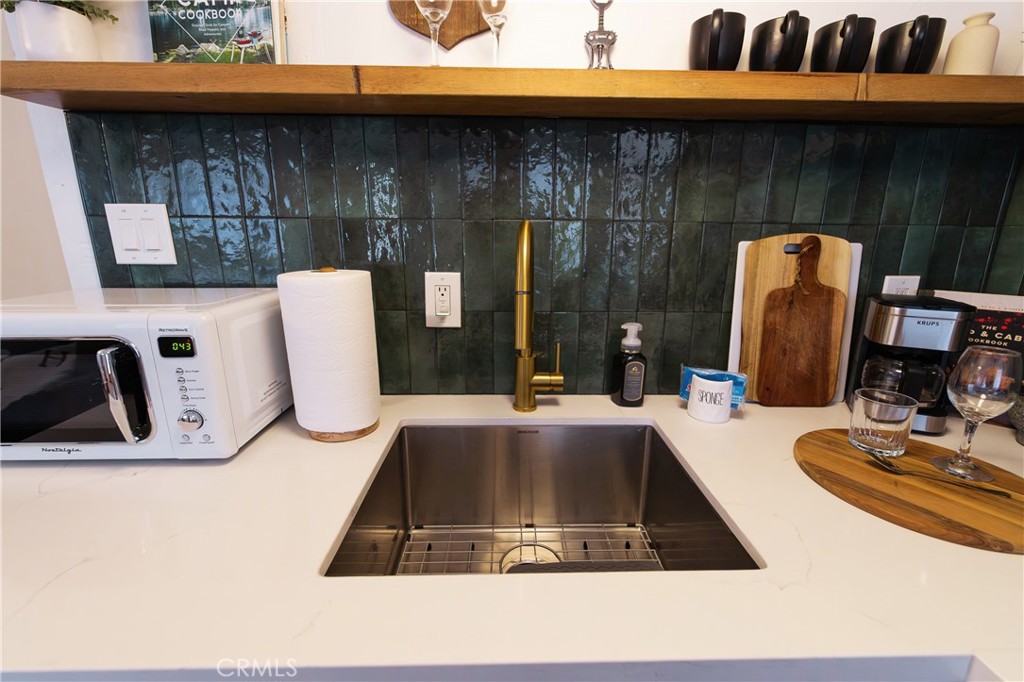 376 Riverside Avenue Sugarloaf, CA 92386 - Photo 12 of 28 a kitchen with a sink a counter top space and cabinets