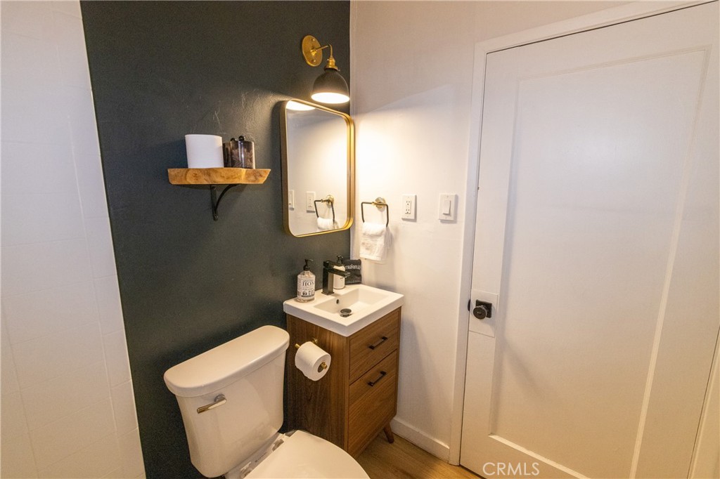 376 Riverside Avenue Sugarloaf, CA 92386 - Photo 17 of 28 a bathroom with a toilet a sink and mirror