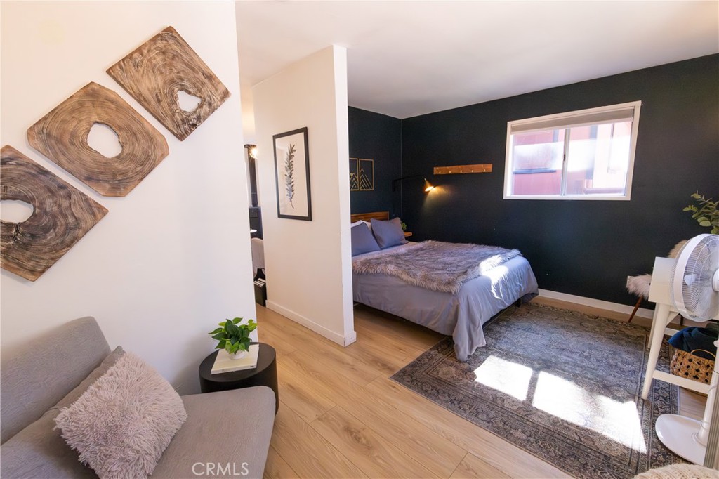 376 Riverside Avenue Sugarloaf, CA 92386 - Photo 19 of 28 a bedroom with a bed and wooden floor