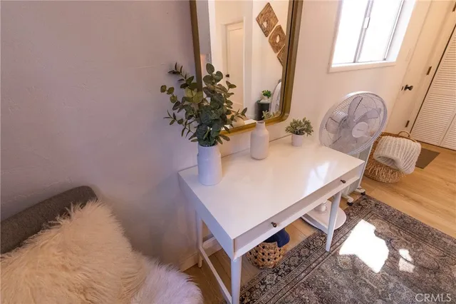 a bed room with a bed and a painting on the wall