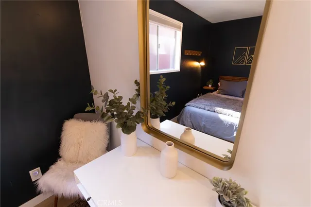 a hallway with a couch and a potted plant