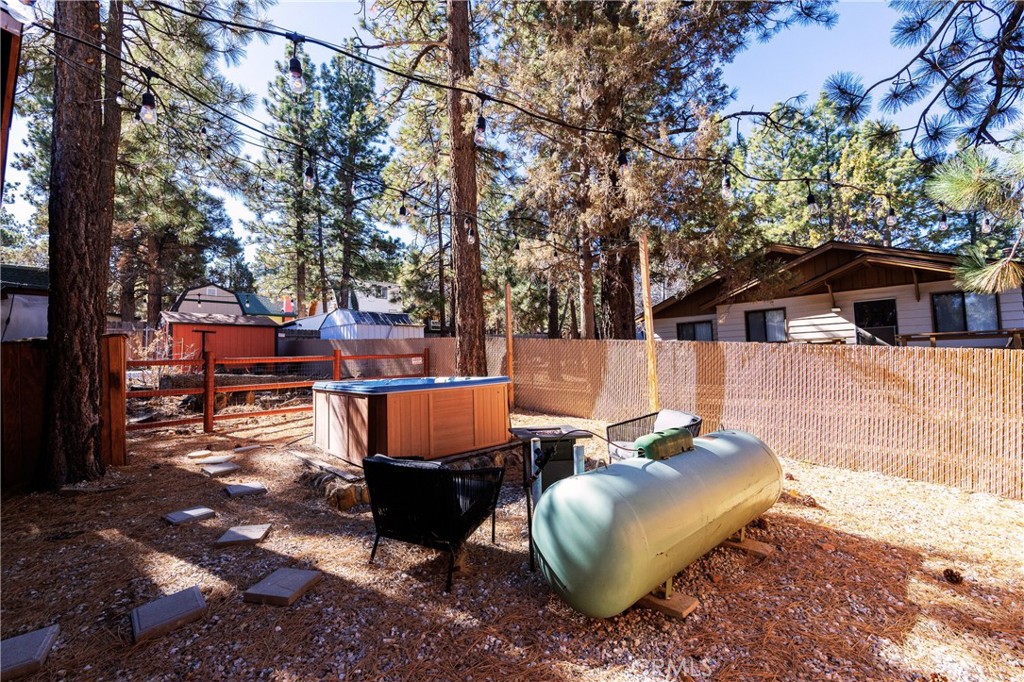 376 Riverside Avenue Sugarloaf, CA 92386 - Photo 28 of 28 a view of a backyard with table and chairs potted plants and large tree