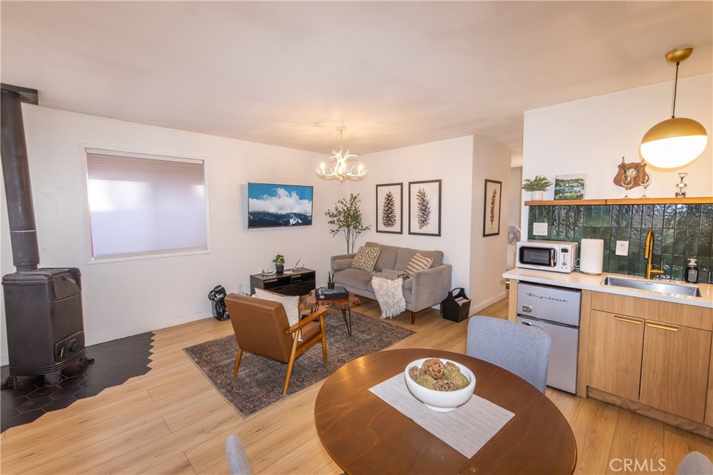 376 Riverside Avenue Sugarloaf, CA 92386 - Photo 6 of 28 a living room with furniture and a wooden floor