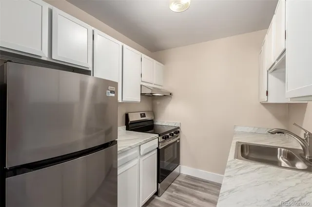 a kitchen with a refrigerator and cabinets