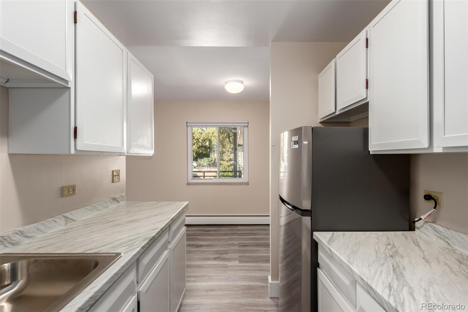830 20th Street, Unit 206 Boulder, CO 80302 - Photo 13 of 27 a kitchen with a refrigerator and cabinets