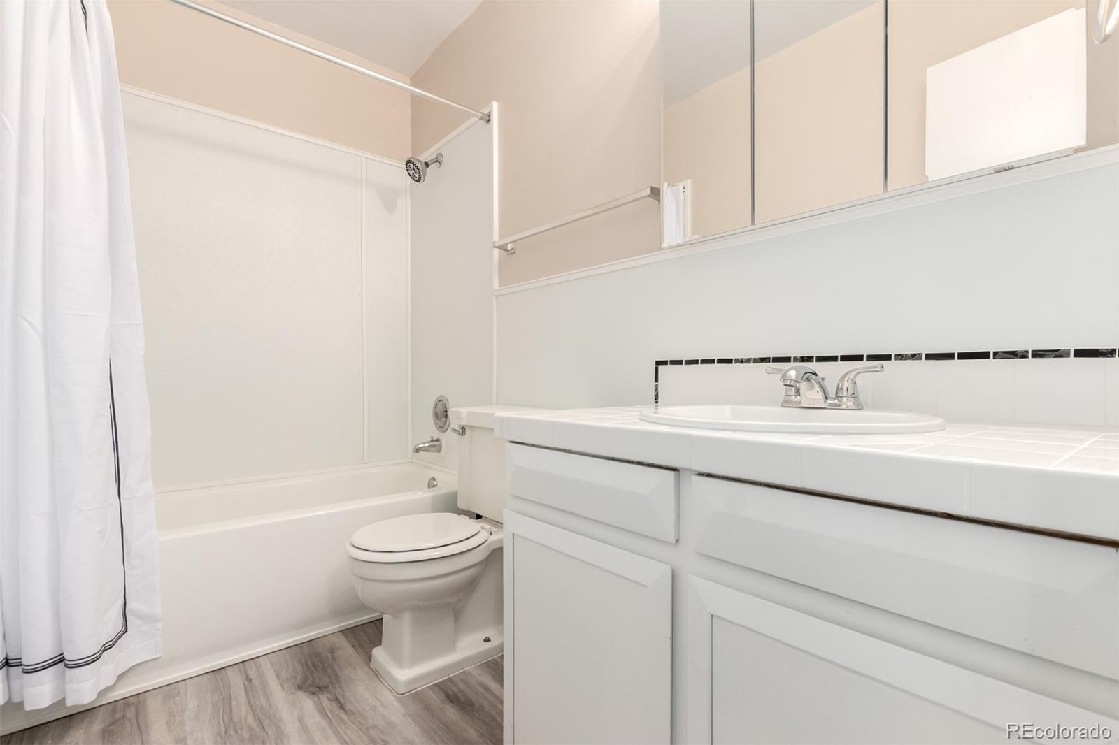 830 20th Street, Unit 206 Boulder, CO 80302 - Photo 22 of 27 a bathroom with a sink a toilet and shower
