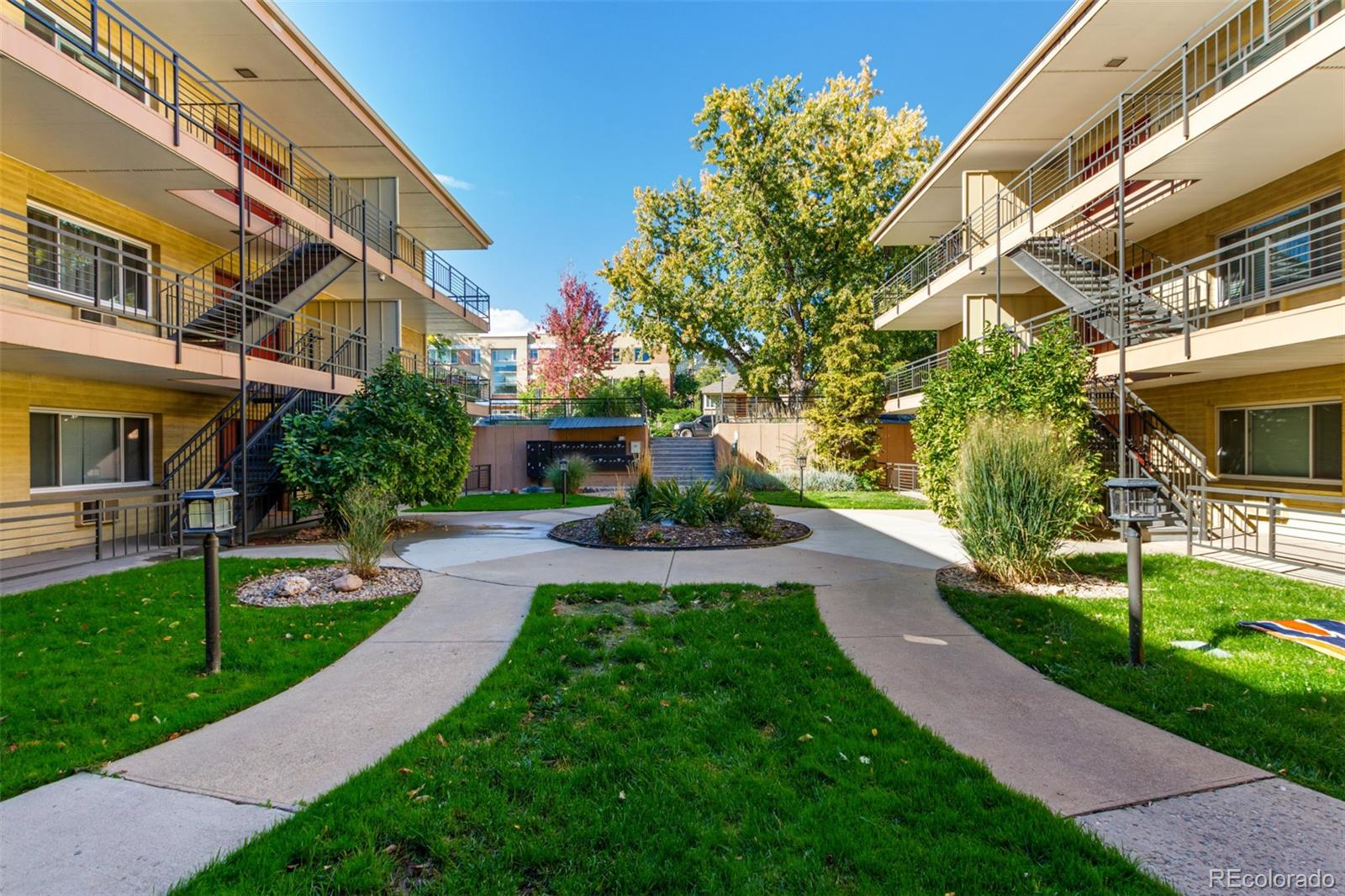 830 20th Street, Unit 206 Boulder, CO 80302 - Photo 3 of 27 a front view of a house with a yard
