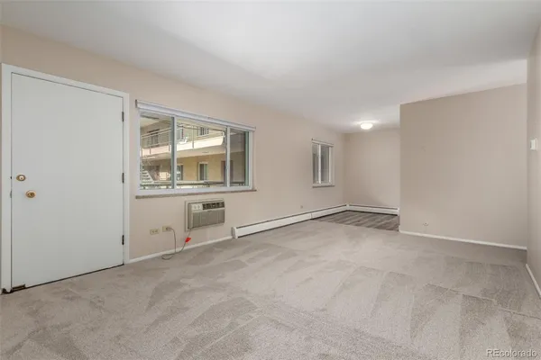 an empty room with a empty space and windows