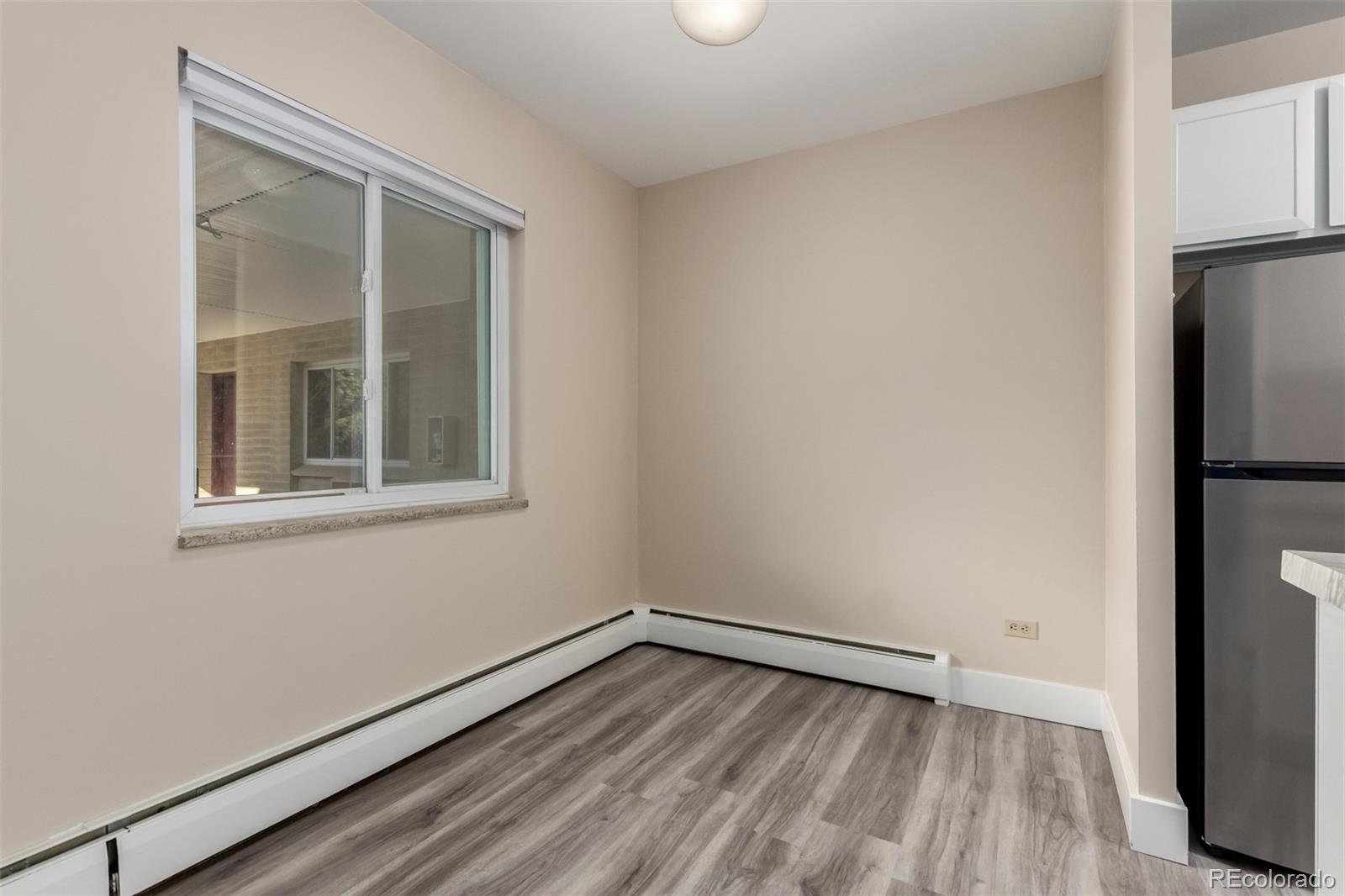 830 20th Street, Unit 206 Boulder, CO 80302 - Photo 10 of 27 a view of an empty room with wooden floor and a window