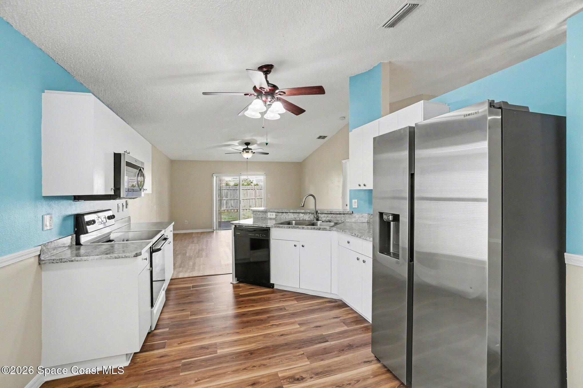 2547 Deercroft Drive Melbourne, FL 32940 - Photo 13 of 35 a kitchen with stainless steel appliances a refrigerator sink and stove