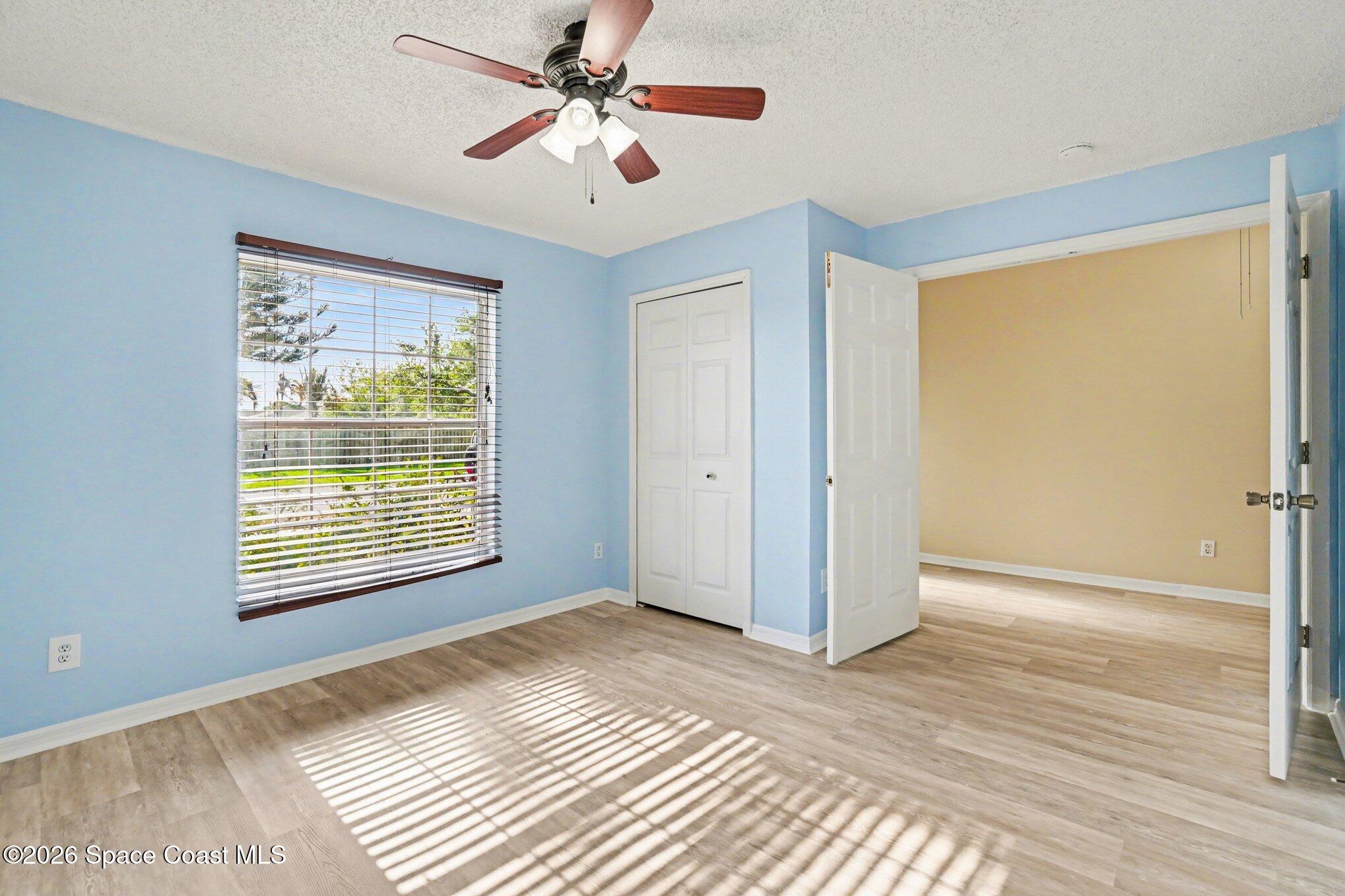 2547 Deercroft Drive Melbourne, FL 32940 - Photo 21 of 35 a view of an empty room with window and wooden floor