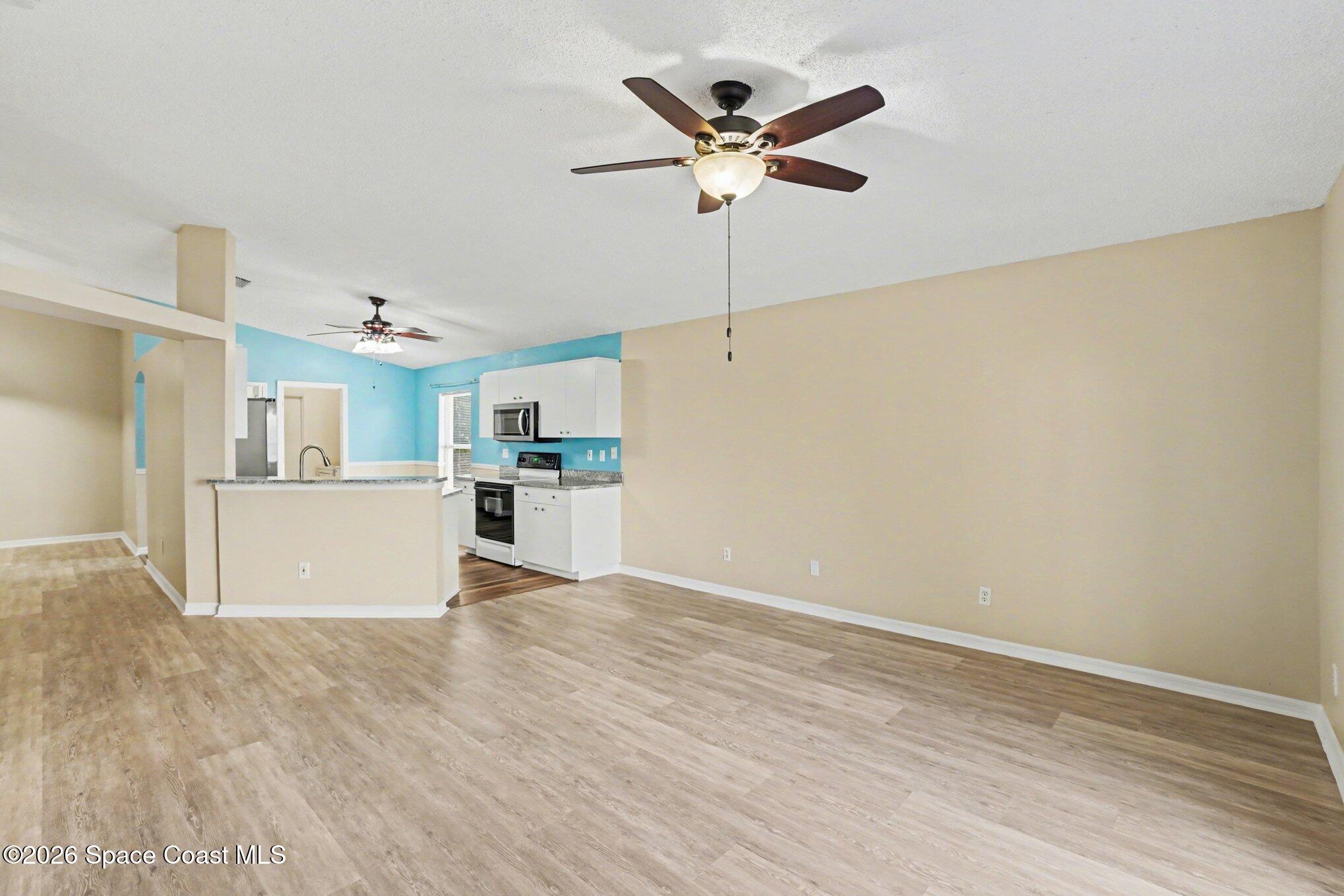 2547 Deercroft Drive Melbourne, FL 32940 - Photo 9 of 35 a view of a kitchen with microwave and cabinets