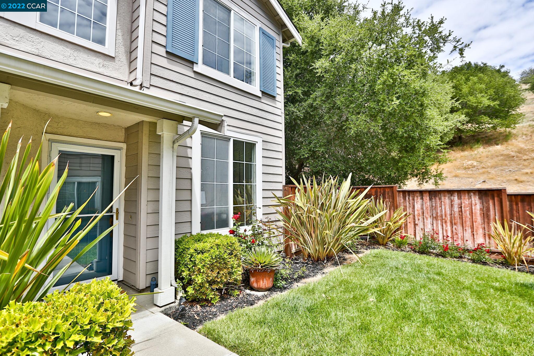 a view of a house with a yard and plants