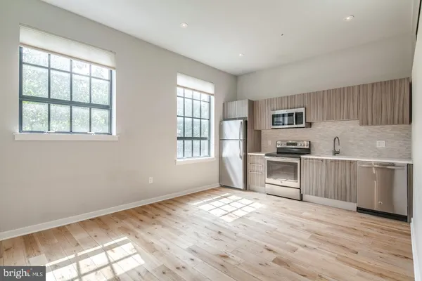 a kitchen with granite countertop white cabinets and appliances