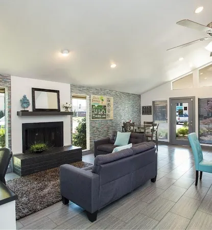a living room with furniture and a fireplace