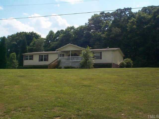 13160 Virgilina Road Roxboro, NC 27574 - Photo 1 of 1 a front view of a house with a garden