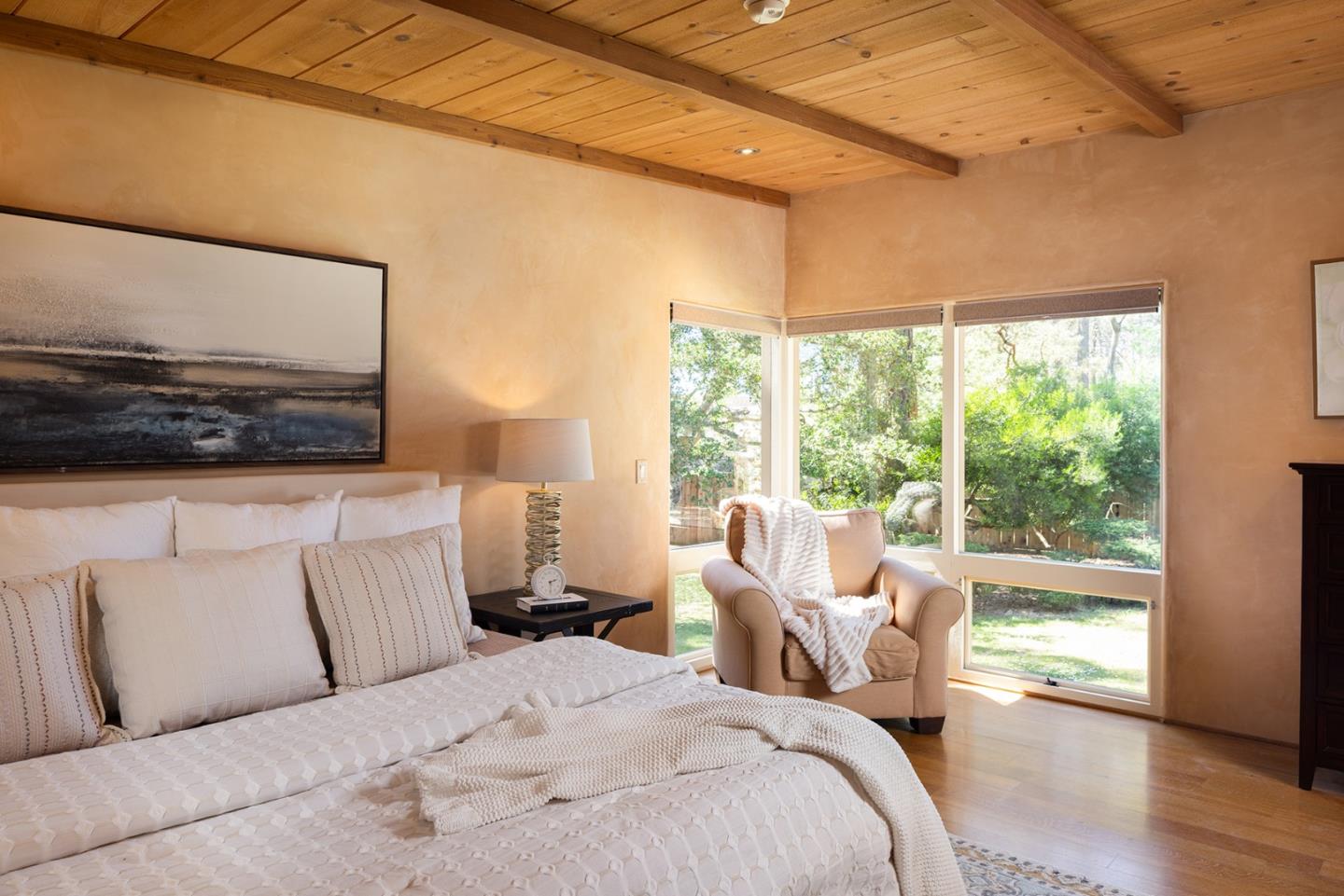 1318 Chamisal Way Pebble Beach, CA 93953 - Photo 11 of 24 a bedroom with a bed and wooden floor