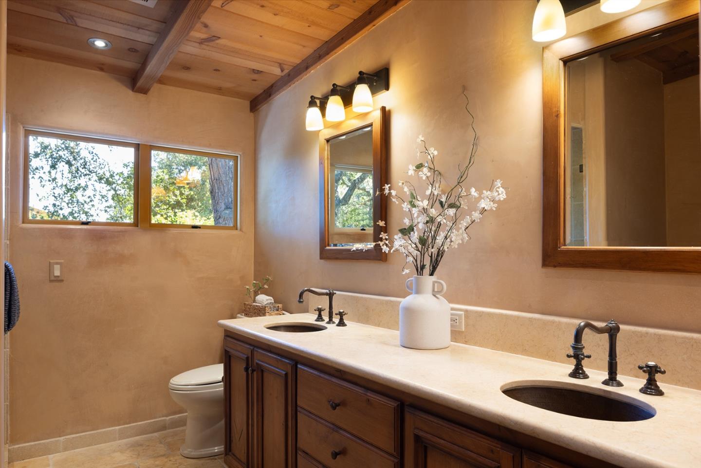1318 Chamisal Way Pebble Beach, CA 93953 - Photo 13 of 24 a bathroom with a double vanity sink toilet and a mirror