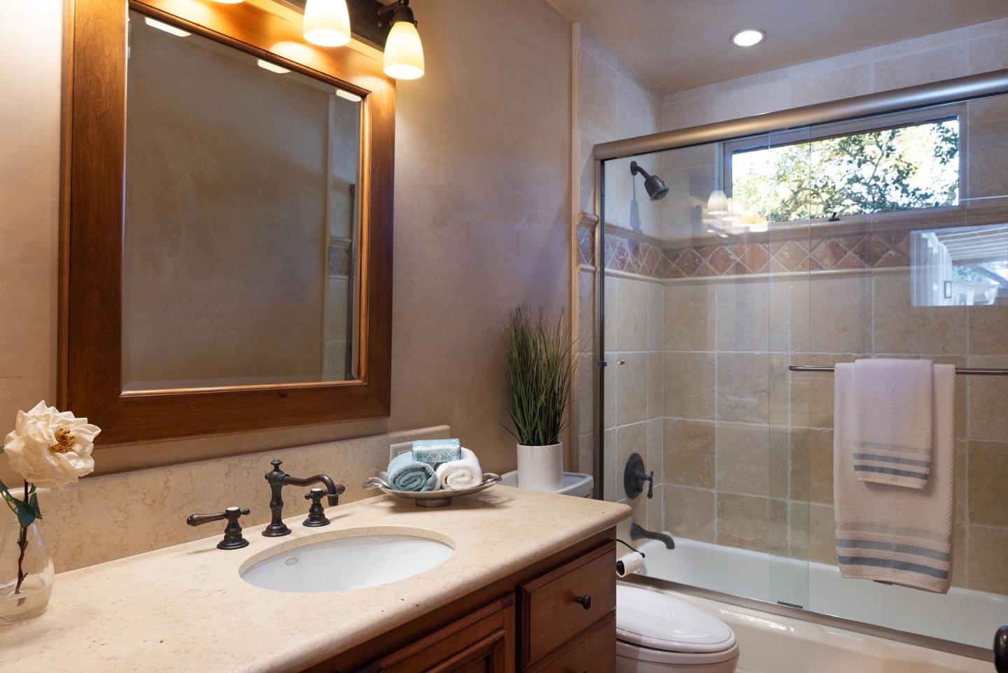 1318 Chamisal Way Pebble Beach, CA 93953 - Photo 16 of 24 a bathroom with a sink a toilet and shower