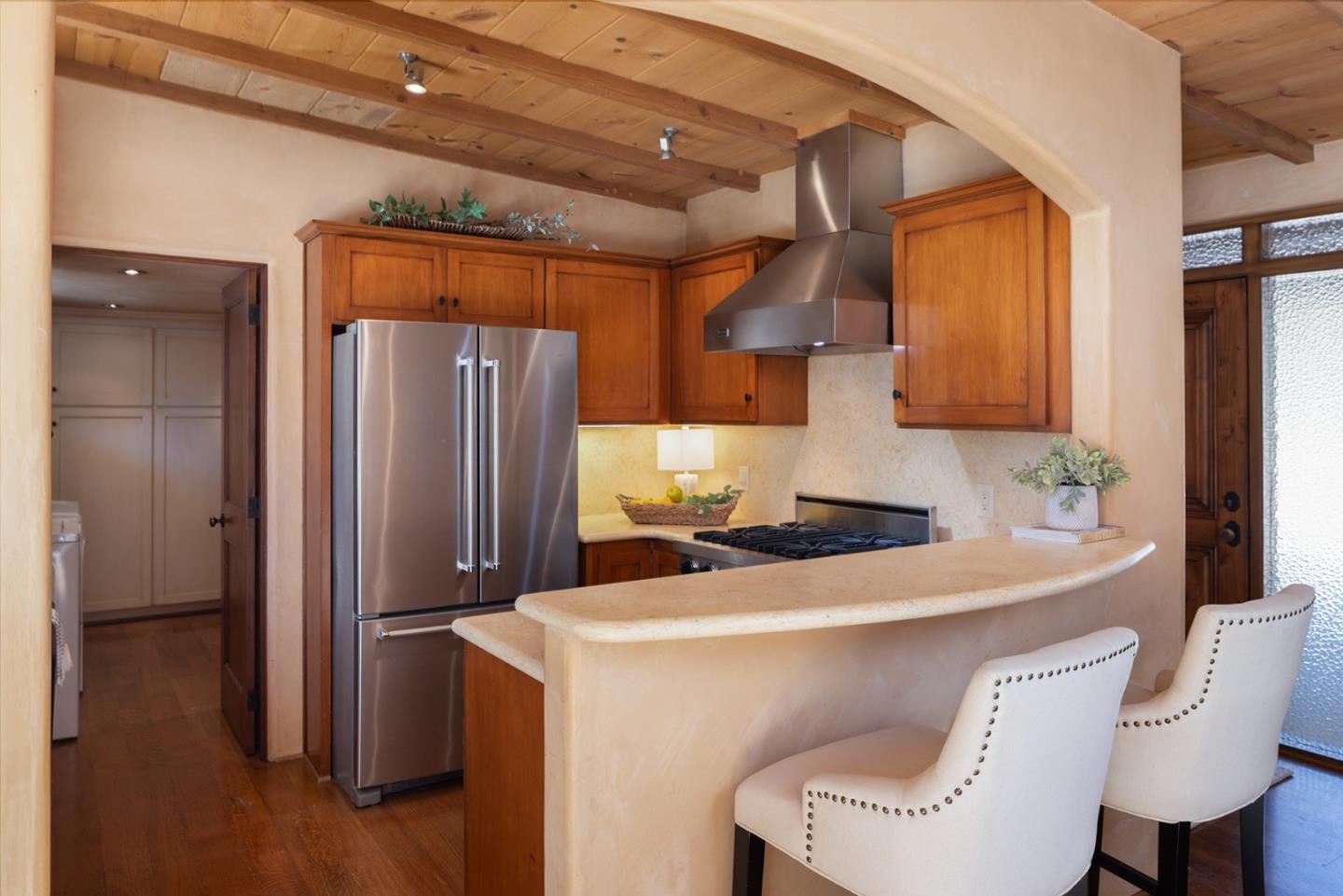 1318 Chamisal Way Pebble Beach, CA 93953 - Photo 8 of 24 a kitchen with stainless steel appliances a refrigerator and a table
