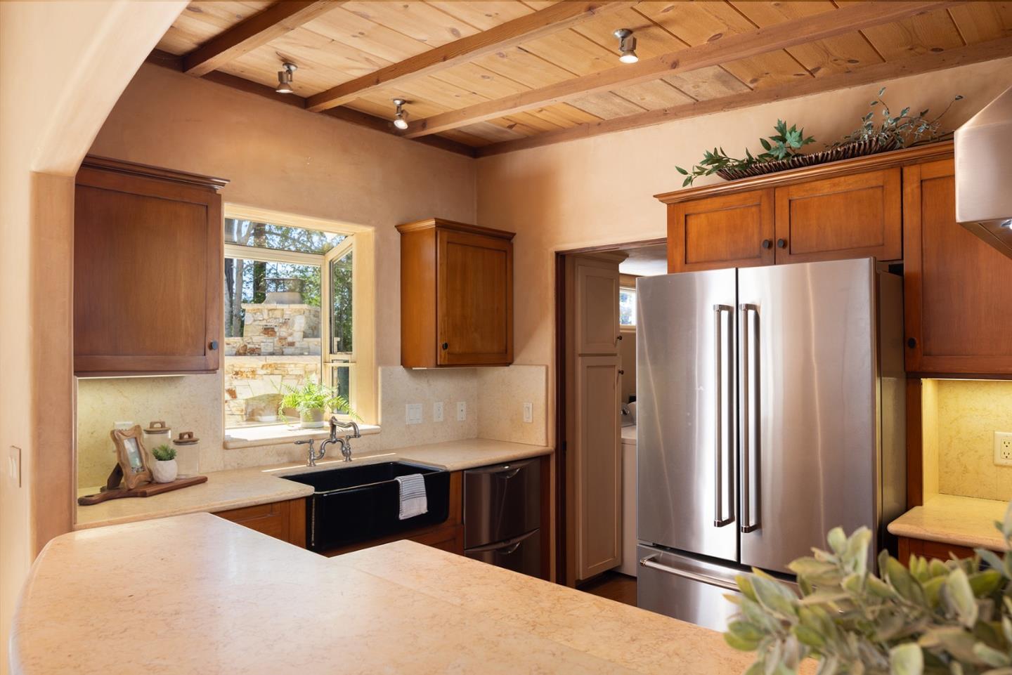 1318 Chamisal Way Pebble Beach, CA 93953 - Photo 10 of 24 a kitchen with stainless steel appliances kitchen island granite countertop a refrigerator and a sink