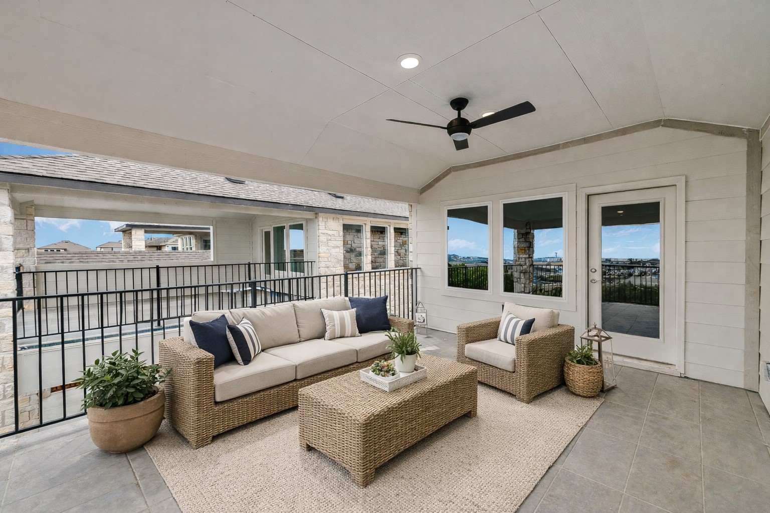 17306 Hattie Trace Austin, TX 78738 - Photo 27 of 37 a living room with furniture ceiling fan and a floor to ceiling window