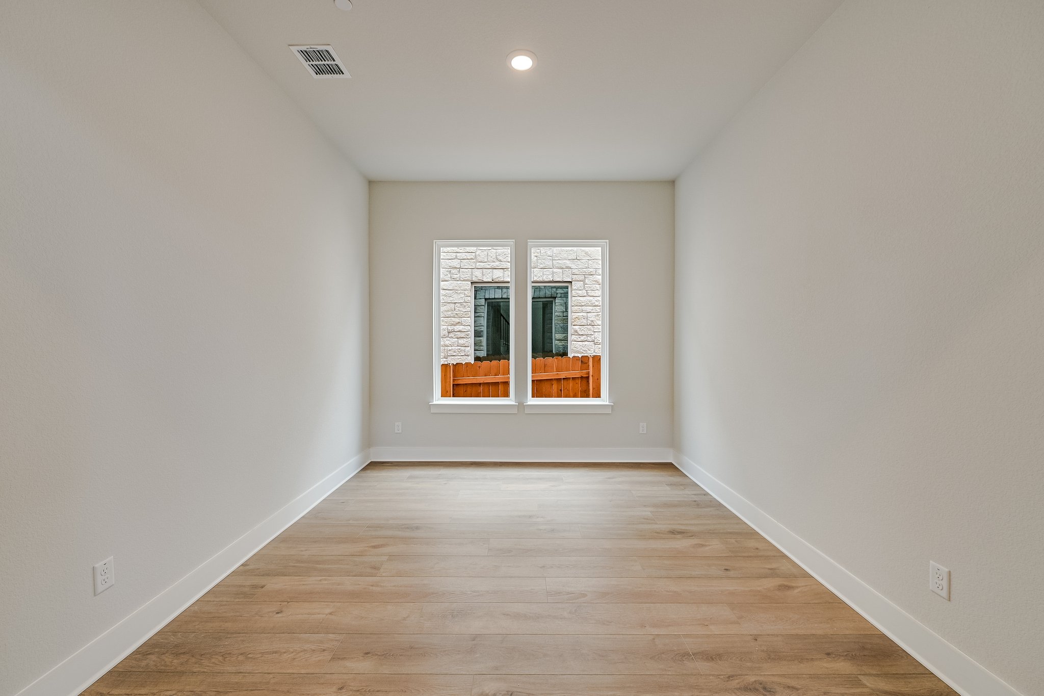 17306 Hattie Trace Austin, TX 78738 - Photo 4 of 37 an empty room with wooden floor and windows