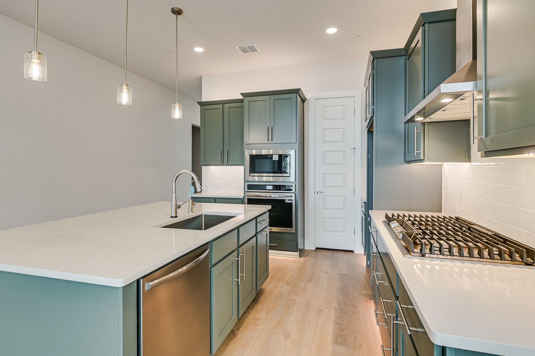 17306 Hattie Trace Austin, TX 78738 - Photo 7 of 37 a kitchen with kitchen island a sink stove and refrigerator