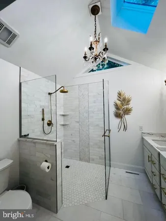 a bathroom with a shower a toilet and sink