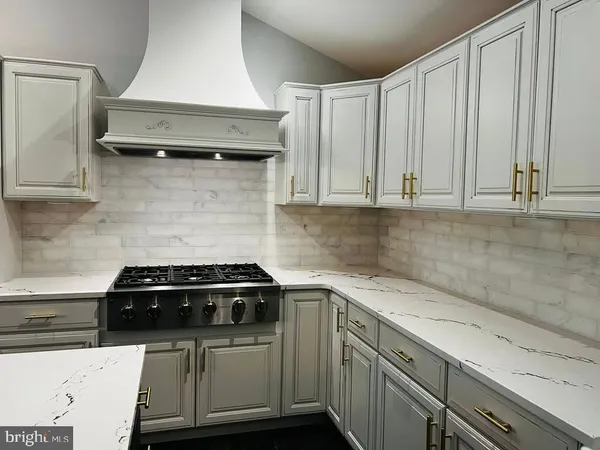 a stove top oven sitting inside of a kitchen