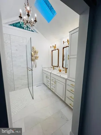 a bathroom with a double vanity sink a toilet and shower