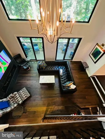 a view of living room with furniture and a floor to ceiling window