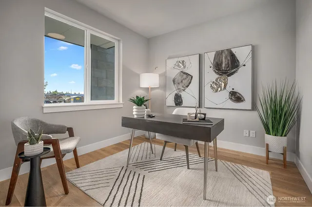 a view of a work space with furniture and window