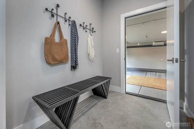 a view of a room with wooden floor and mirror