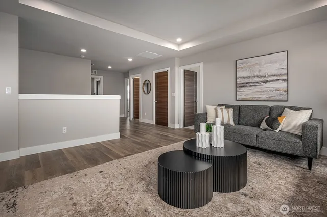 a living room with furniture and a wooden floor
