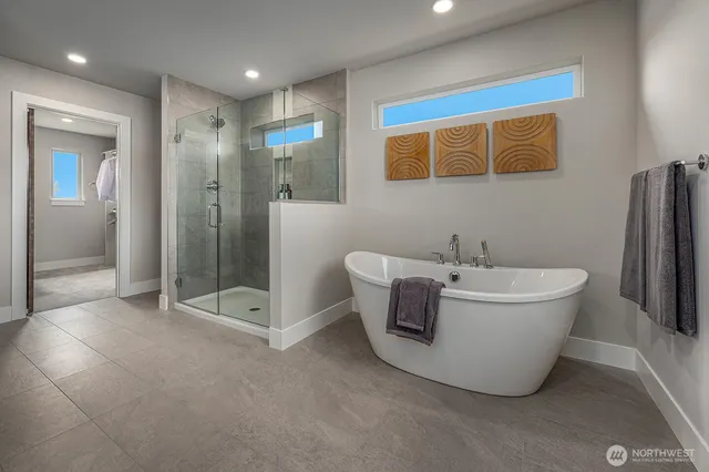 a bathroom with a bathtub and shower