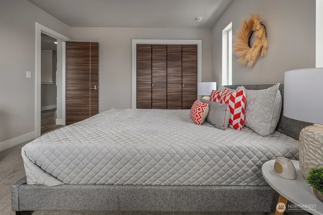 a bedroom with a large bed and a window