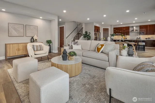 a living room with furniture and a view of kitchen
