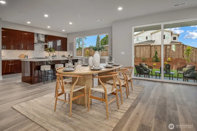 a dining room filled a table and a potted plant