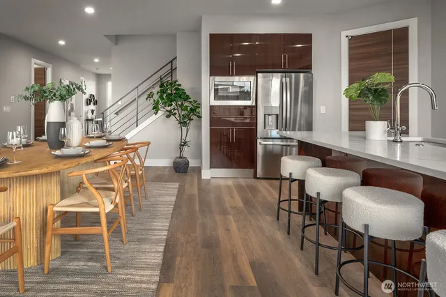 a dining room with furniture and wooden floor