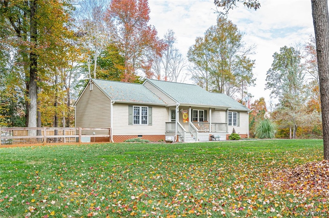 a front view of a house with a yard and trees