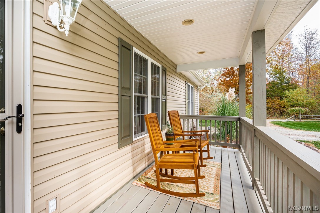 14490 Meade Road Amelia Court House, VA 23002 - Photo 5 of 25 a balcony with chairs and wooden floor
