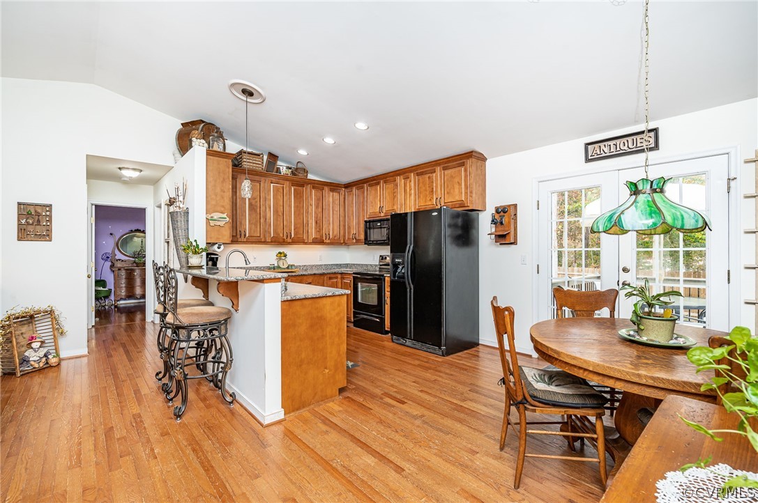 14490 Meade Road Amelia Court House, VA 23002 - Photo 10 of 25 a kitchen with stainless steel appliances a dining table chairs stove refrigerator and cabinets