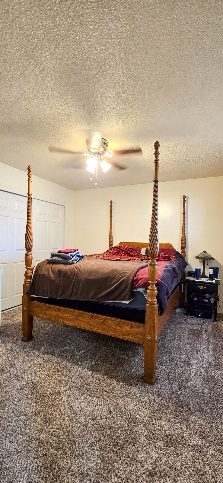813 West Alene Avenue Ridgecrest, CA 93555 - Photo 18 of 26 a bedroom with a bed and a chandelier