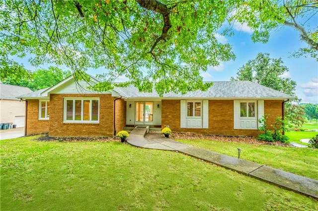 a view of a house with a backyard