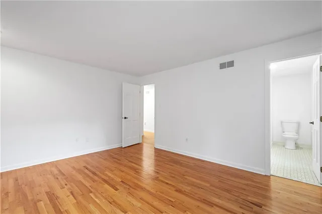 a view of an empty room and wooden floor