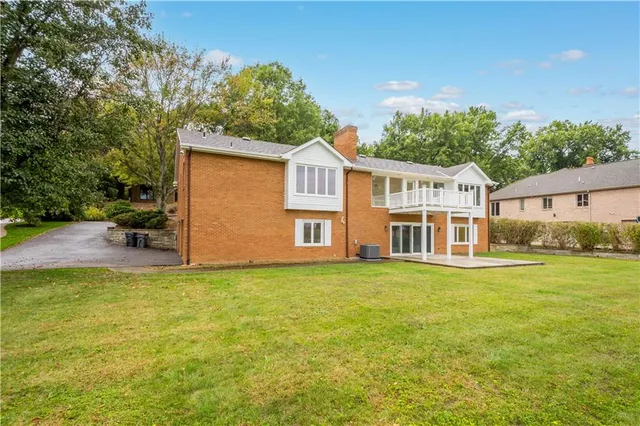 a view of a house with a yard and a garden