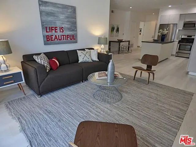 a living room with furniture and a rug